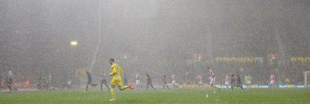 The players leave the pitch due to hail