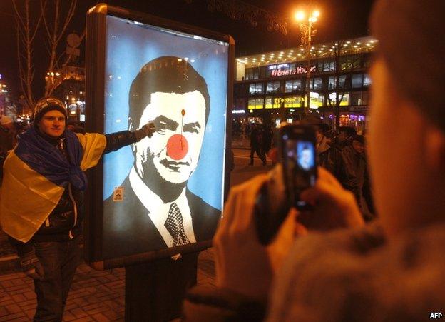 A defaced photo of Ukrainian President Viktor Yanukovych in Kiev, 19 December