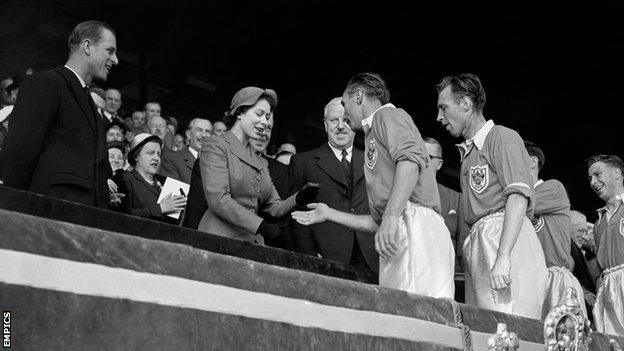 Stanley Matthews collects his 1953 FA Cup winners medal from Queen Elizabeth II