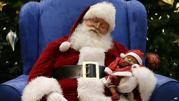 Santa and sleeping baby