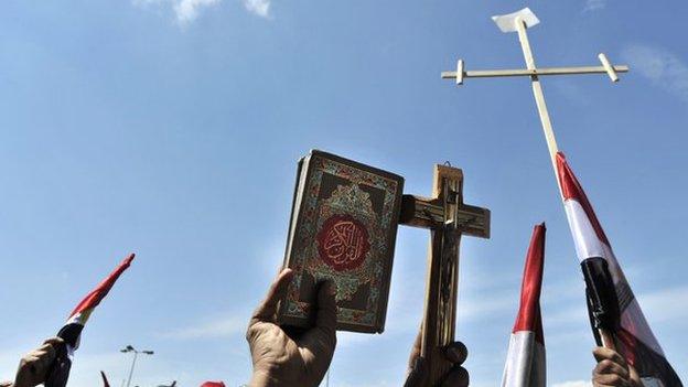 Protesters hold crosses and a Koran in demonstrations against sectarianism in Cairo, 2011