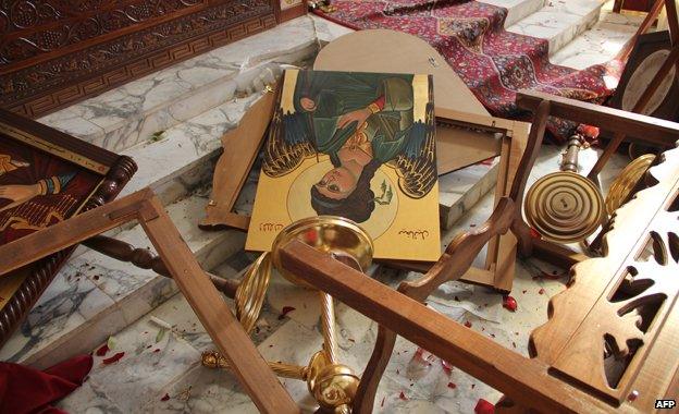 Icons and overturned furniture on the ground at the church of Saint Michael in the Syrian village of Qara, November 2013