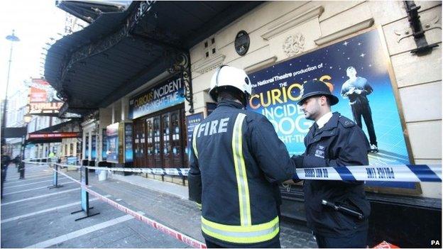 Firefighter and police officer outside the Apollo Theatre