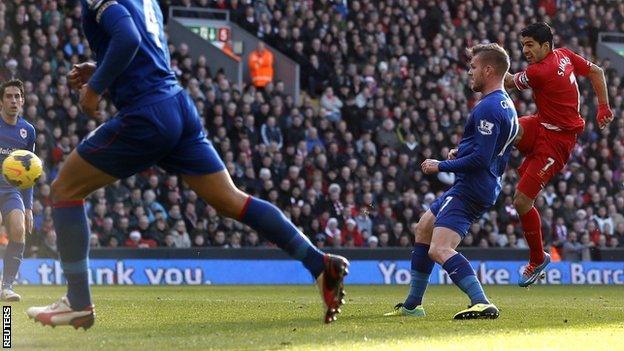 Liverpool striker Luis Suarez (right) volleys in against Cardiff at Anfield