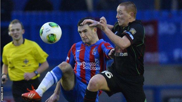 Glentoran's Stephen McAlorum battles with Scott Davidson of Ards