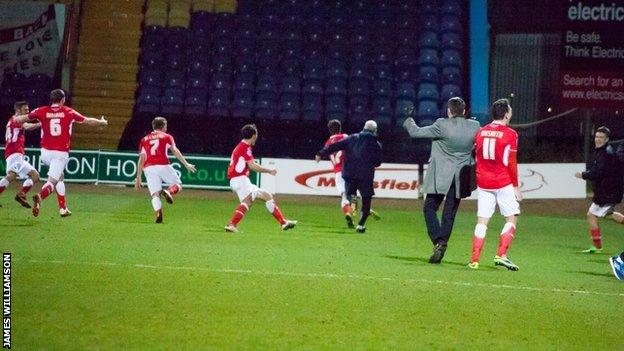 Accrington's players celebrate their late winner against Mansfield