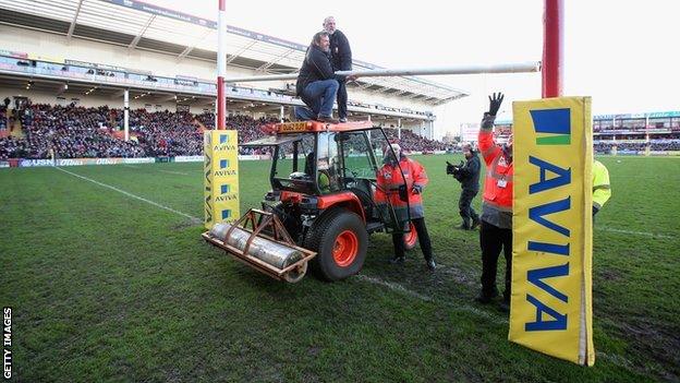 They eventually bring in a tractor to put the bar back in place