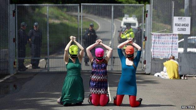 Demonstrators wear "Free Pussy Riot" balaclavas as they protest at the security fence surrounding the G8 Summit at Lough Erne in Enniskillen, Northern Ireland June 17, 2013