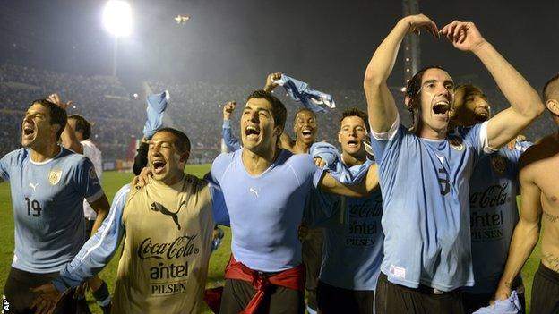 Uruguay players Andres Scotti, Walter Gargano, Luis Suarez and Diego Godin celebrate qualifying for the 2014 World Cup after beating Jordan in the play-off in Montevideo