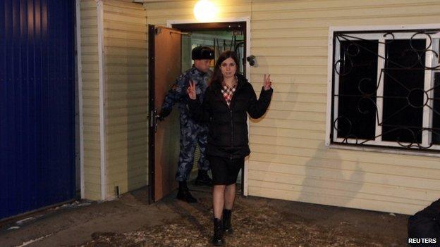 Nadezhda Tolokonnikova gestures as she walks out of prison in Krasnoyarsk