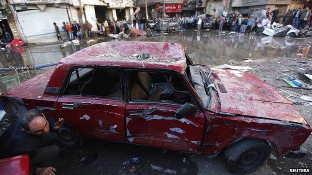 A damaged car is seen after the explosion in Mansoura.