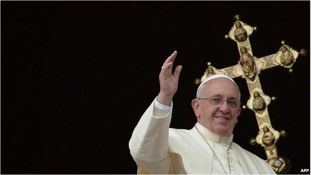 Pope Francis waves to the crowd after his traditional Christmas "Urbi et Orbi" blessing from the balcony of St. Peter's Basilica on December 26