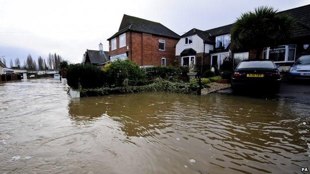 Overflowing River Stour encroaching onto a residential street near Bournemouth