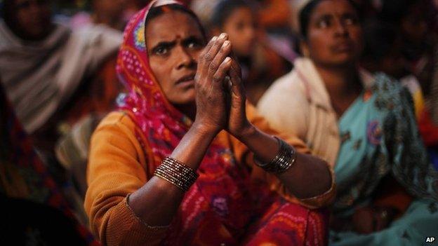 A Dalit woman listens to a speaker with folded hands during a protest on Human Rights Day near the Indian Parliament in Delhi, Tuesday, Dec 10, 2013