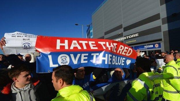 Fans protesting with banners outside Cardiff City stadium