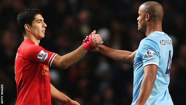 Liverpool's Luis Suarez shakes hands with Man City's Vincent Kompany