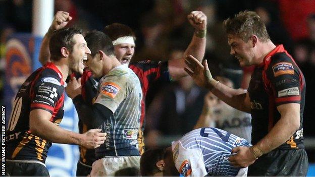 Dragons players celebrate at the final whistle of their match against Cardiff Blues