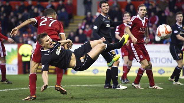 Shaun Hutchinson (below left) challenges for the ball with Aberdeen's Michael Hector