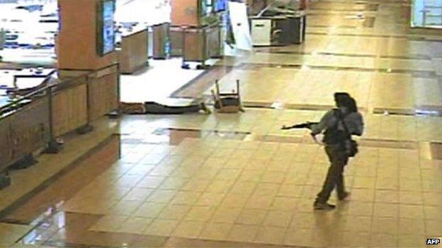 This screen grab released on Ocotber 18, 2013 and taken from closed circuit television shows an armed man walking during the attack at the Westgate mall in Nairobi on September 21, 2013.