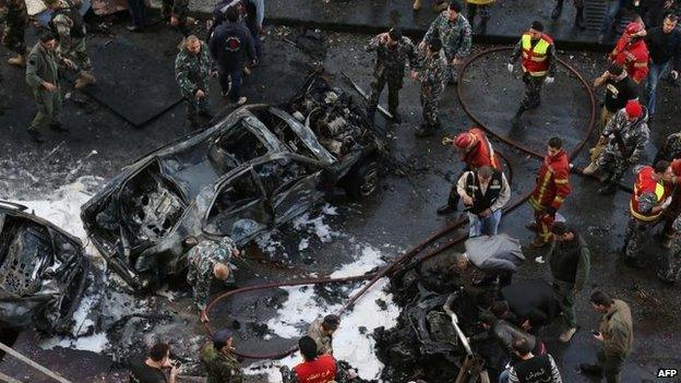 Security forces and firefighters at the scene of car bomb explosion in Beirut which killed Mohamad Chatah (27 December)