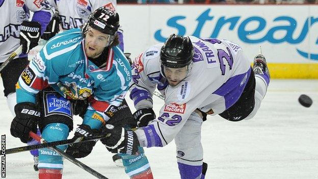 Darryl Lloyd of the Belfast Giants in action against Chris Frank of the Breahead Clan