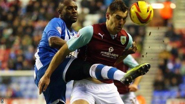 Wigan Athletic's Emerson Boyce challenges Burnley's Sam Vokes