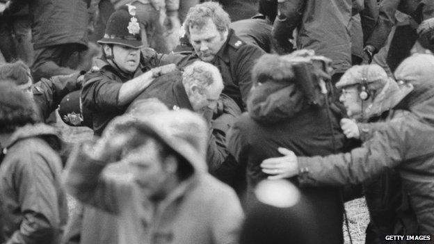 A camera crew films a scuffle between police and miners at a demonstration at Orgreave Colliery, South Yorkshire, during the miner's strike, 1984.