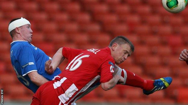 Linfield defender Kyle McVey challenges Warrenpoint's Liam Bagnall