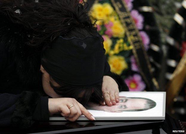 A relative grieves over the coffin of a victim of the Volgograd attacks, 31 December