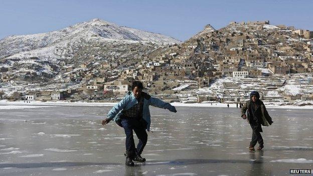 Afghan children play on a frozen lake in Kabul, December 31, 2013. REUTERS/Omar Sobhani