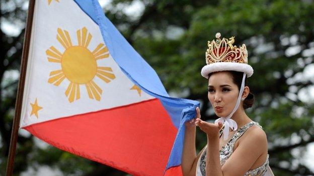 Miss International 2013 winner of the Philippines Bea Rose Santiago blows a kiss to the crowd during a victory parade in Manila on 27 December 2013