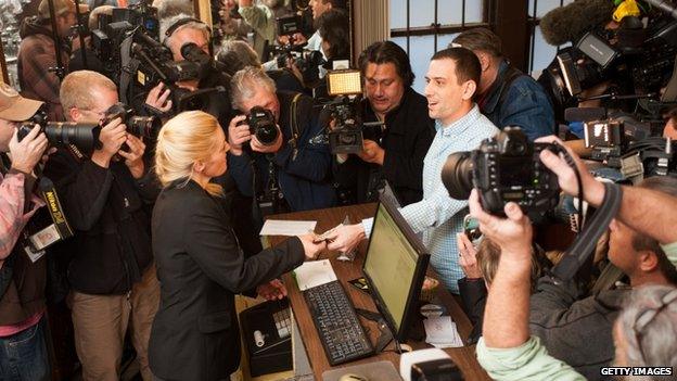 Sean Azzariti, a veteran of the Iraq war, makes the first legal recreational marijuana purchase in Colorado from advocate Betty Aldworth at the 3-D Denver Discrete Dispensary on January 1, 2014 in Denver, Colorado.