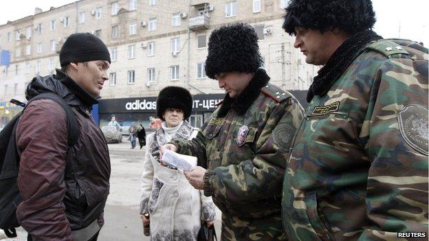 Cossacks check man's papers during street patrol in Volgograd, 2 Jan 14