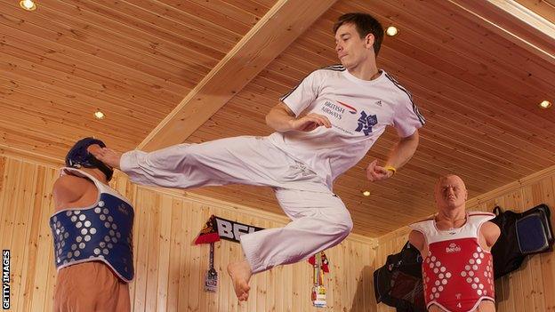 Aaron Cook of Great Britain poses for pictures during a British Airways photo feature at a specially constructed gym.