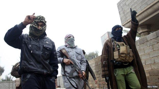 Gunmen walk in the streets of the city of Fallujah, 50 km (31 miles) west of Baghdad January 3, 2014