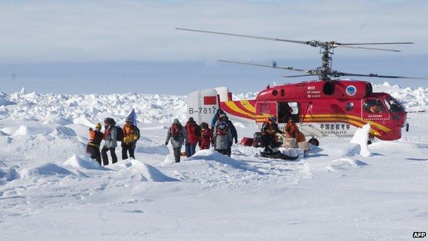 Passengers from the Akademik Shokalskiy in Antarctica disembark from a rescue helicopter from the Chinese ship Xue Long