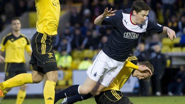 Falkirk's Conor McGrandles is brought down by Coll Donaldson