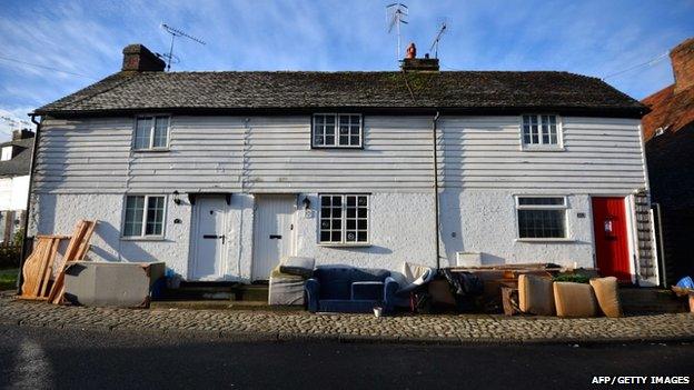 Flood damaged furniture is piled outside homes in the village of Yalding in Kent, southern England