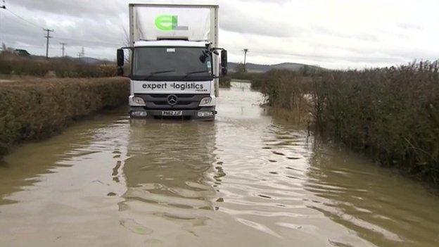 Firefighters used an amphibious vehicle to rescue two men when their lorry broke down in flood water in Tewkesbury, Gloucestershire