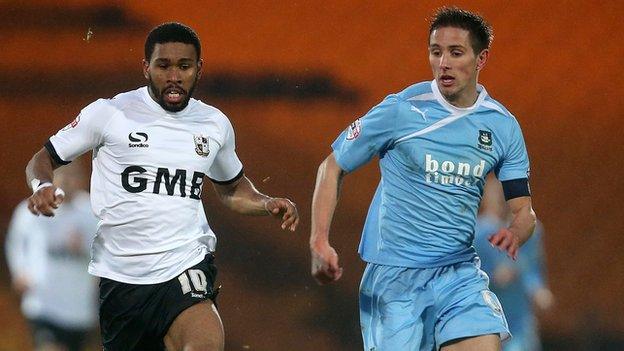 Gavin Tomlin of Port Vale controls the ball from Conor Hourihane of Plymouth Argyle