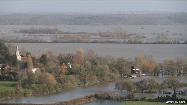 A house in the village of Bury is surrounded by flood water from the River Arun