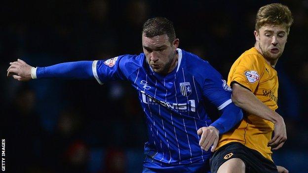 Danny Kedwell (l) and Wolves' Michael Jacobs