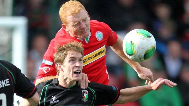 Joe McNeill gets above Glentoran's David Howland