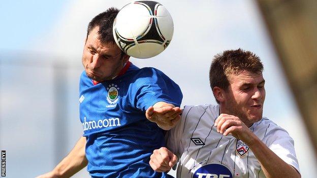 Jim Ervin beats Coleraine's Stephen Lowry to the high ball