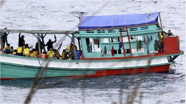 In this photo taken on 14 April 2013, a fishing boat carrying Vietnamese asylum seekers nears the shore of Australia's Christmas Island