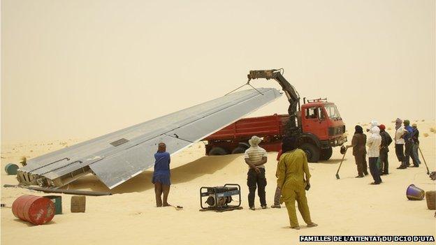 the plane's wing is loaded onto a truck