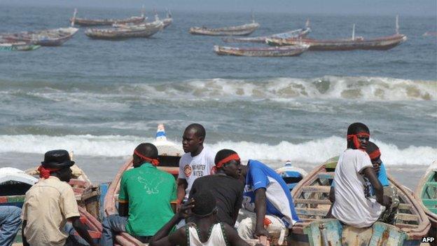 Senegalese fishermen and boat owners wear red headbands in sign of protest as they sit on the beach on 31 March 2011 in Kayar, 52kms(32 miles) north-west of Dakar, during a demonstration against the presence of foreign ships