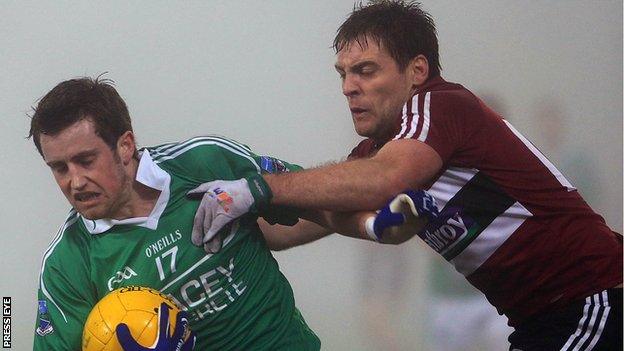 Fermanagh's Niall McElroy is challenged by James Duffy of St Mary's at Brewster Park.