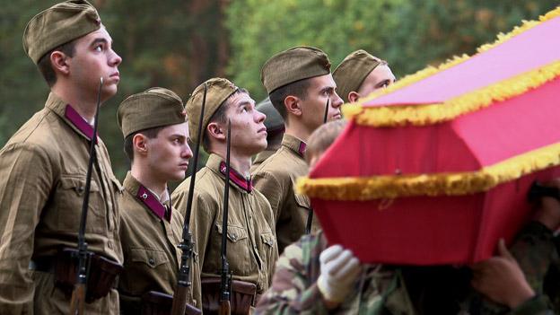young men look up during burial