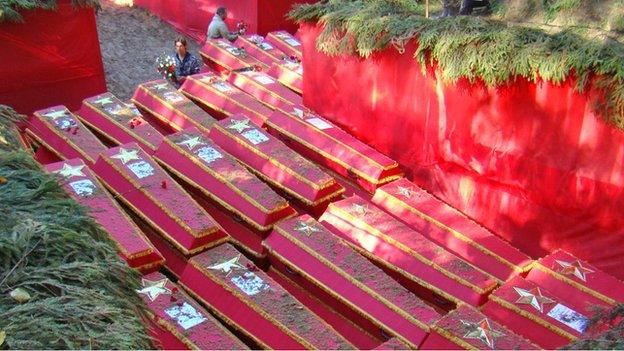 Coffins being buried